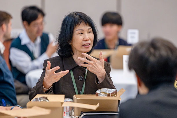 Mentor Stella Pang at table speaking during annual mentor lunch
