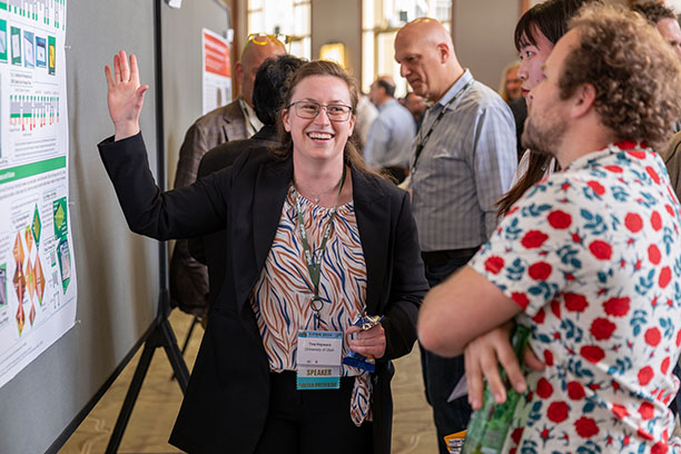 Student presenting during poster session at conference